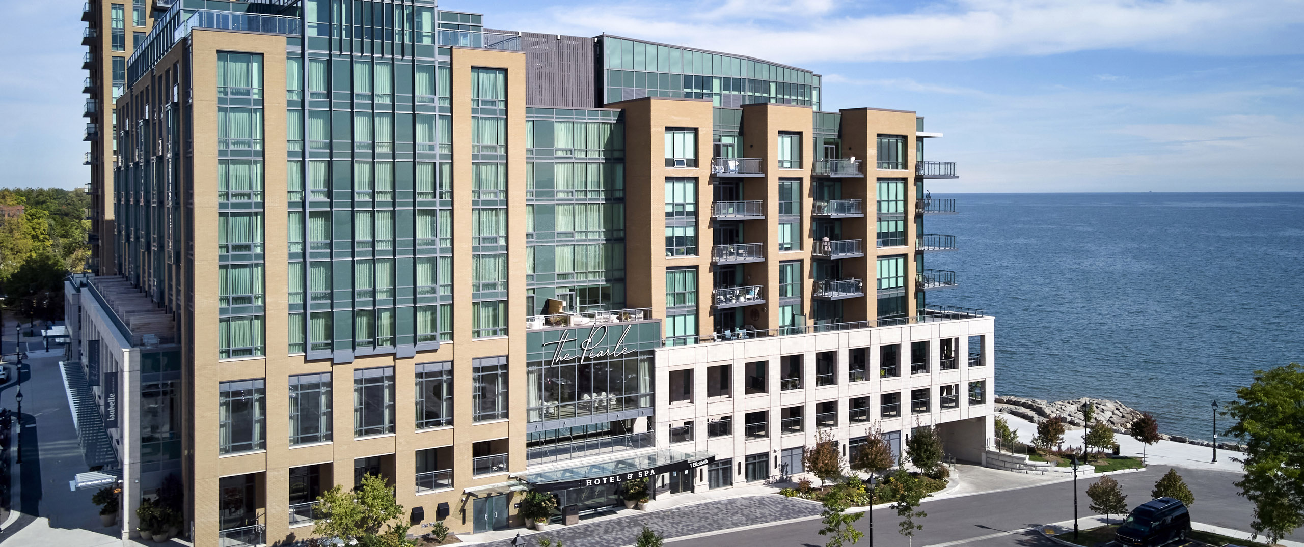 Exterior image of The Pearle Hotel in Burlington Ontario with Lake Ontario in the background