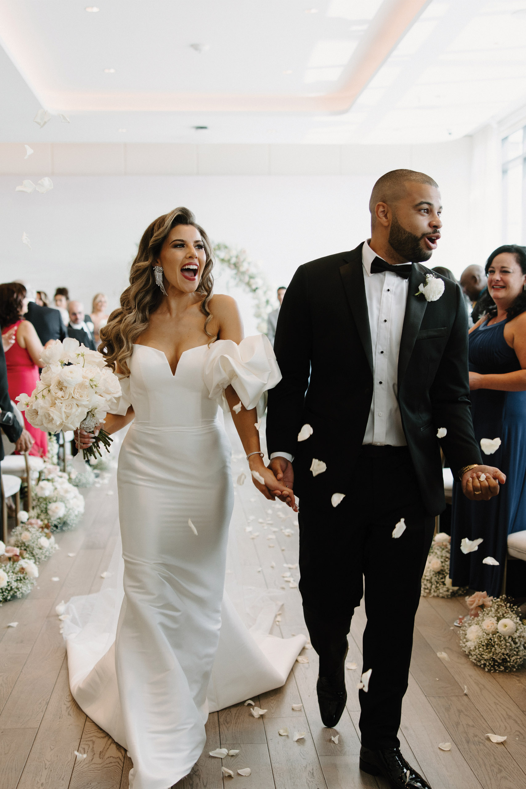 Couple walking down the isle after getting married at The Pearle Hotel