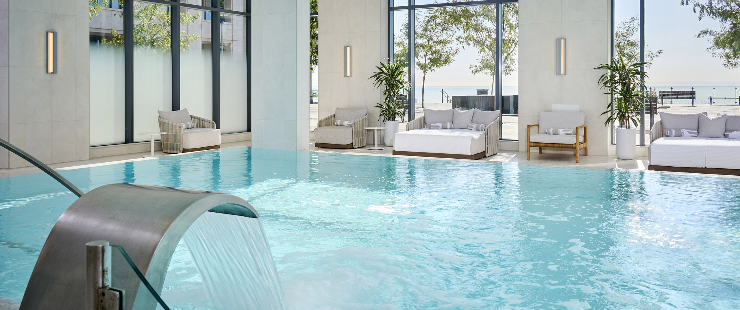 Pool at The Pearle Hotel with large lounge chairs in the background