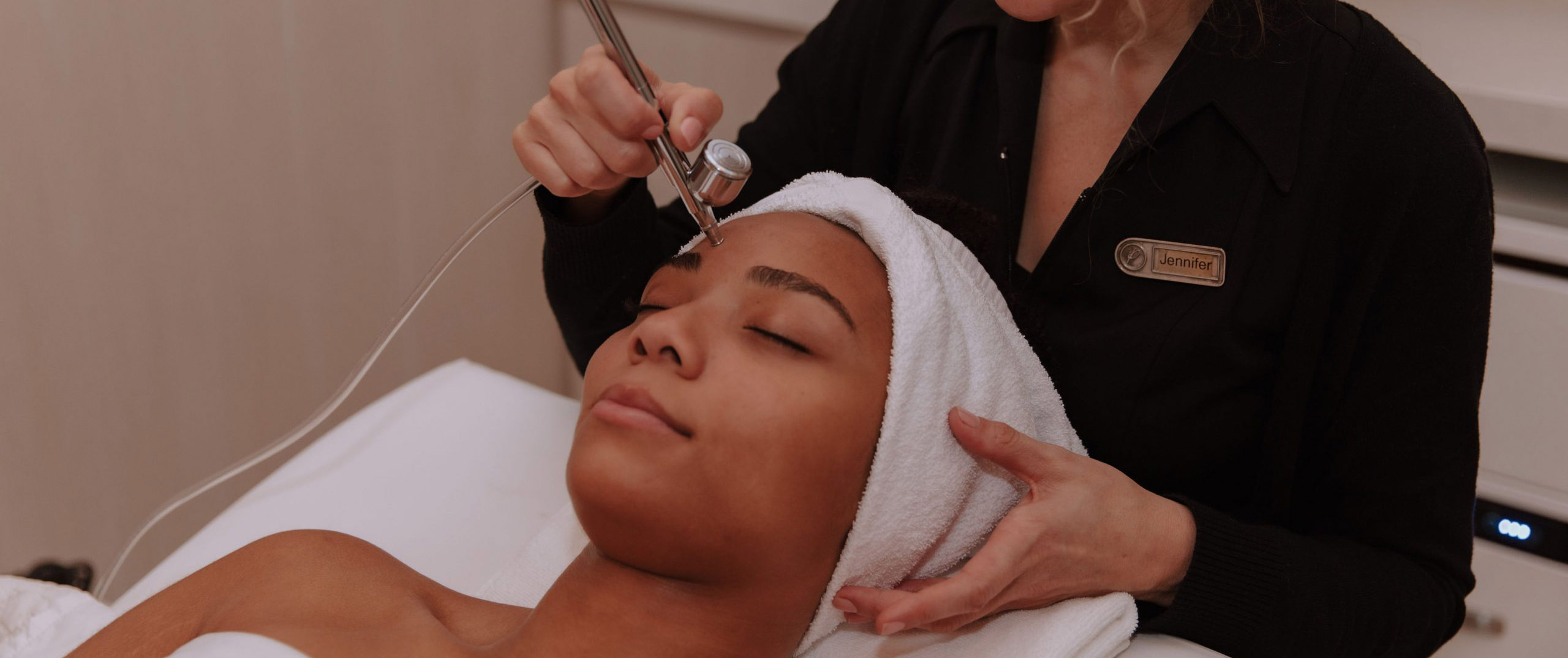 Woman receiving a facial treatment at The Pearle Hotel