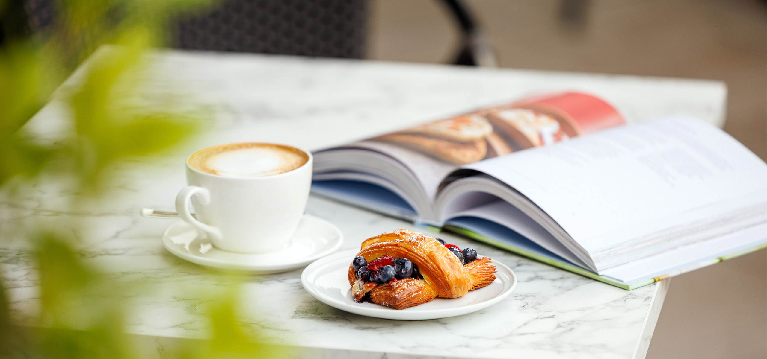 Breakfast pastry and book at the Pearle Café in Burlington