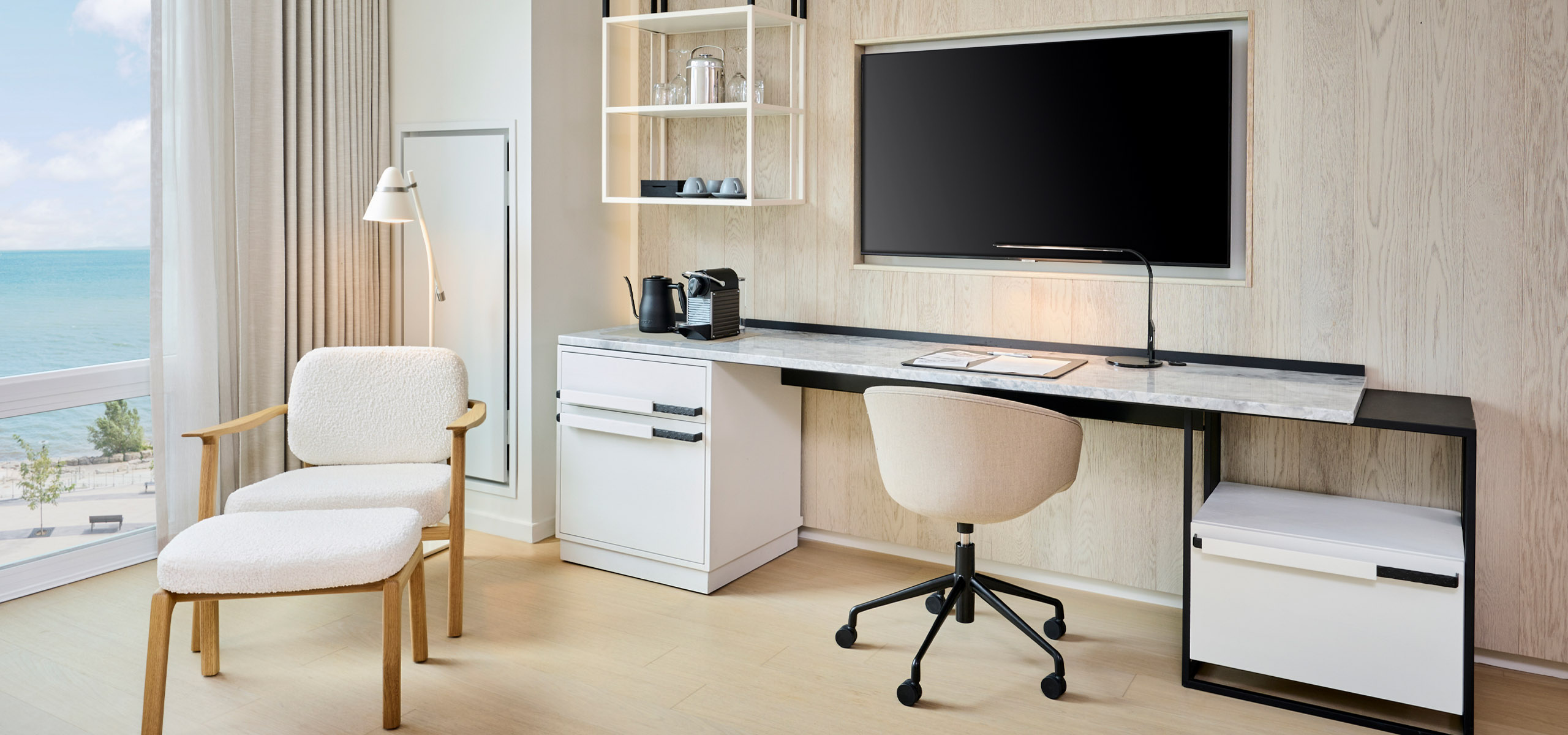 Workspace area with TV in the Studio Suite at The Pearle Hotel