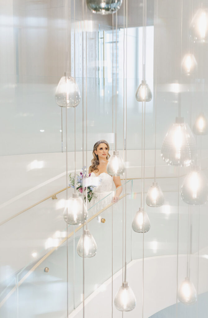 Bride walking down the stairs in The Pearle Hotel lobby