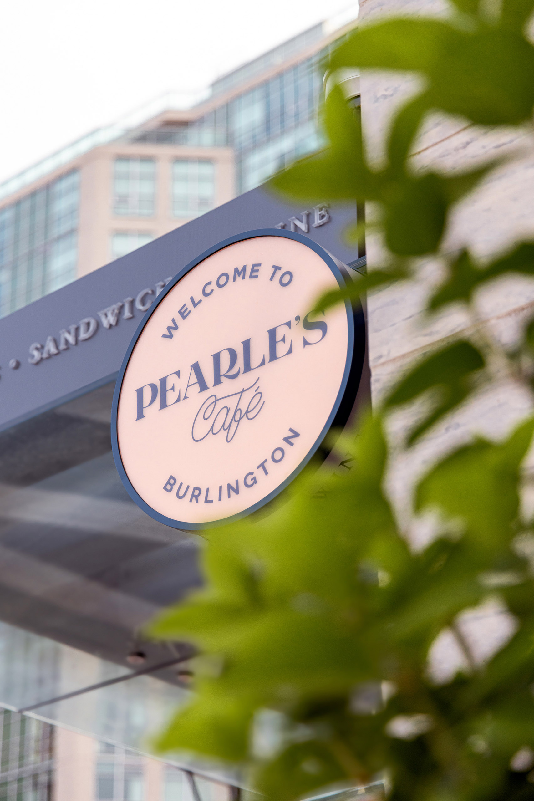 Pink signage on the exterior of The Pearle Café