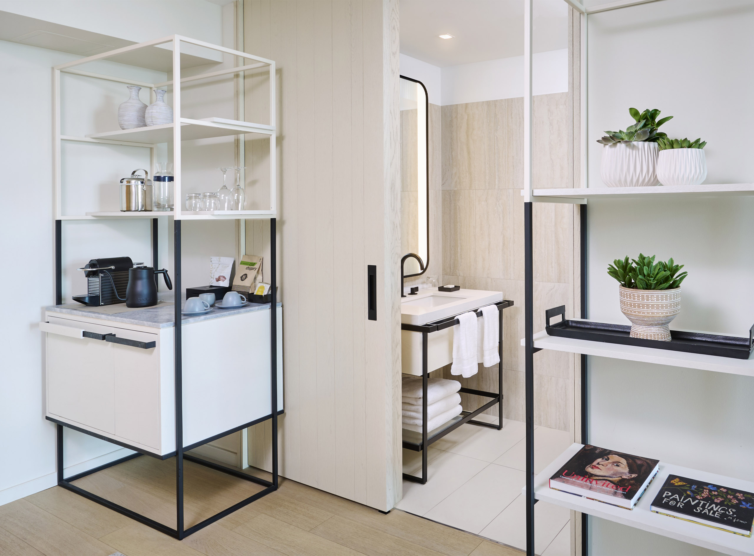 Shelving outside of the bathroom entrance in the James Suite at The Pearle Hotel