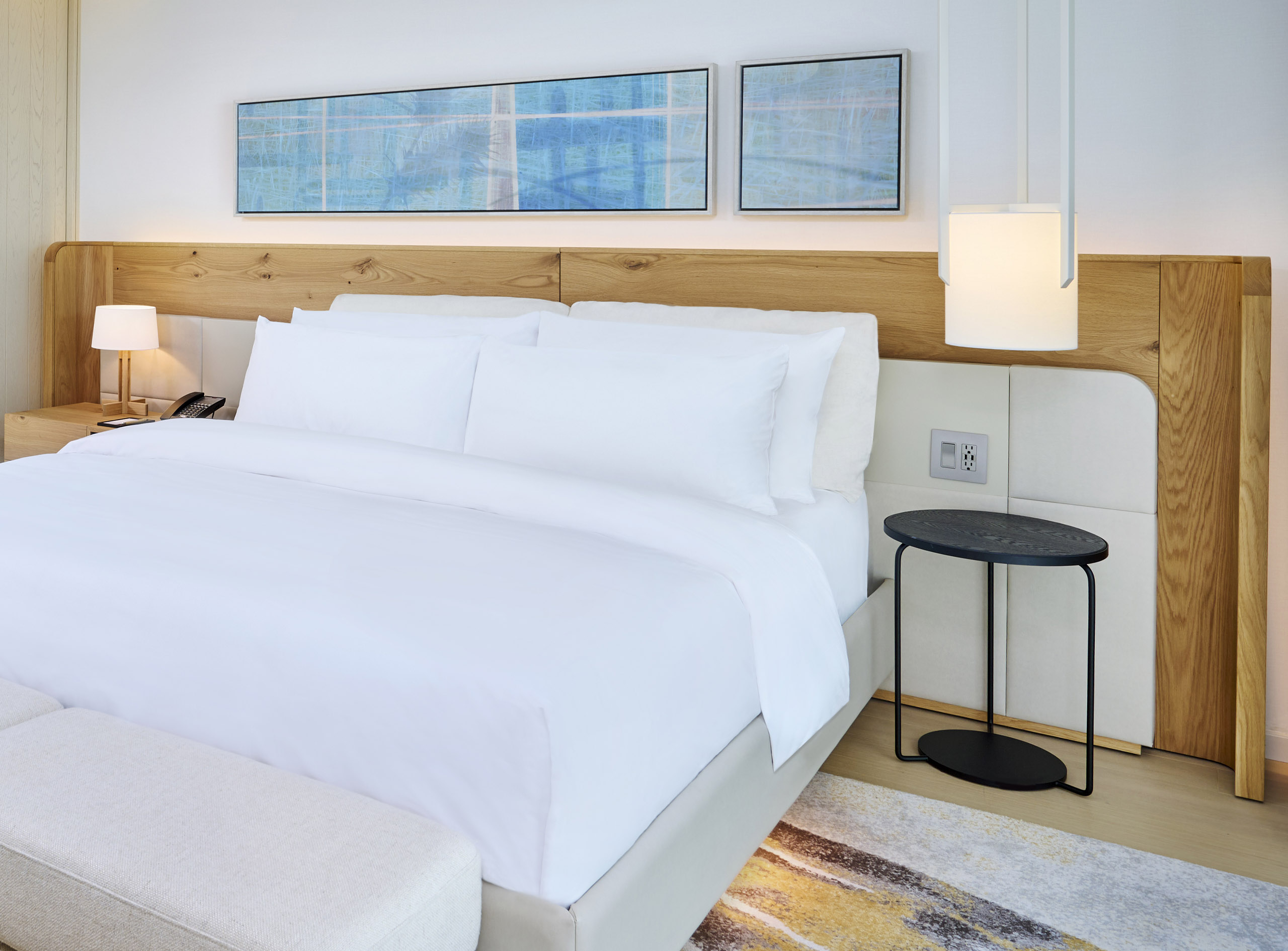 Close up of sleeping area with nightstand in the James Suite at The Pearle Hotel