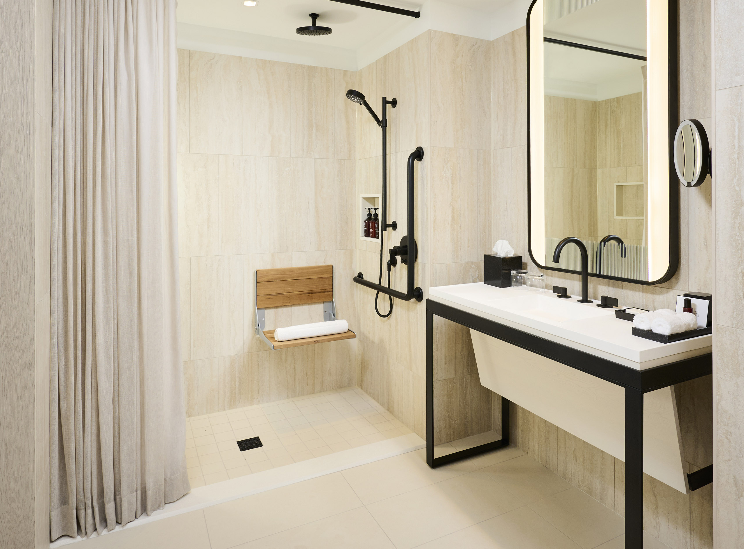 Modern walk-in shower and vanity in the Larger Studio room at The Pearle Hotel