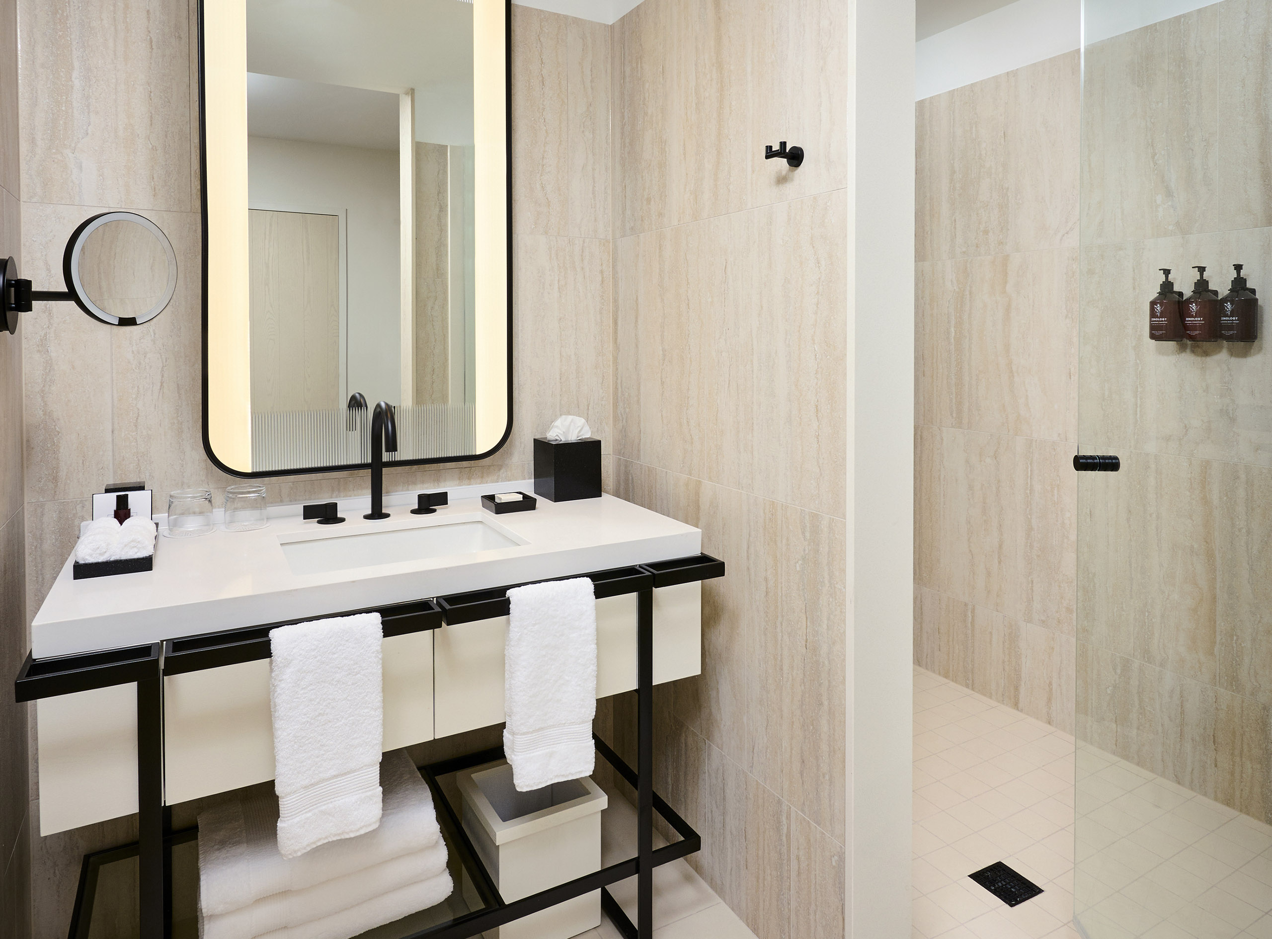 Modern shower and vanity in the Studio King room at The Pearle Hotel