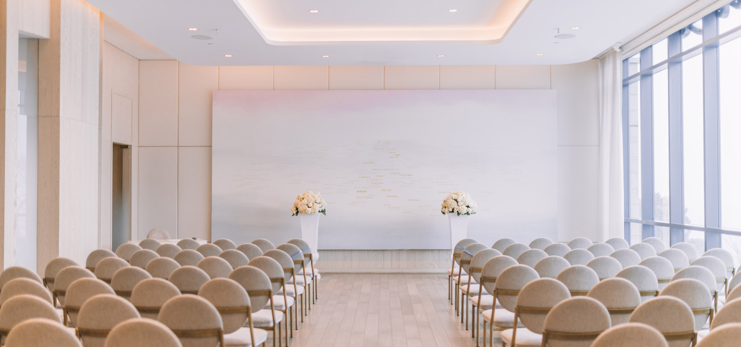 Minimal ceremony alter space with white florals on either side 