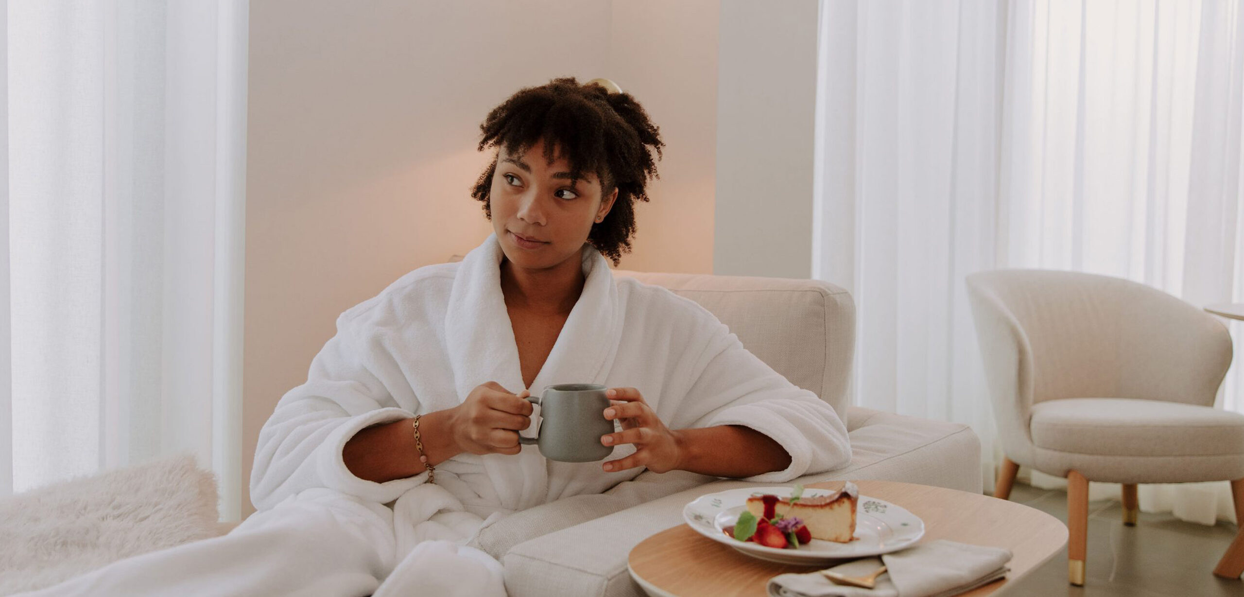 Woman drinking coffee in a spa robe
