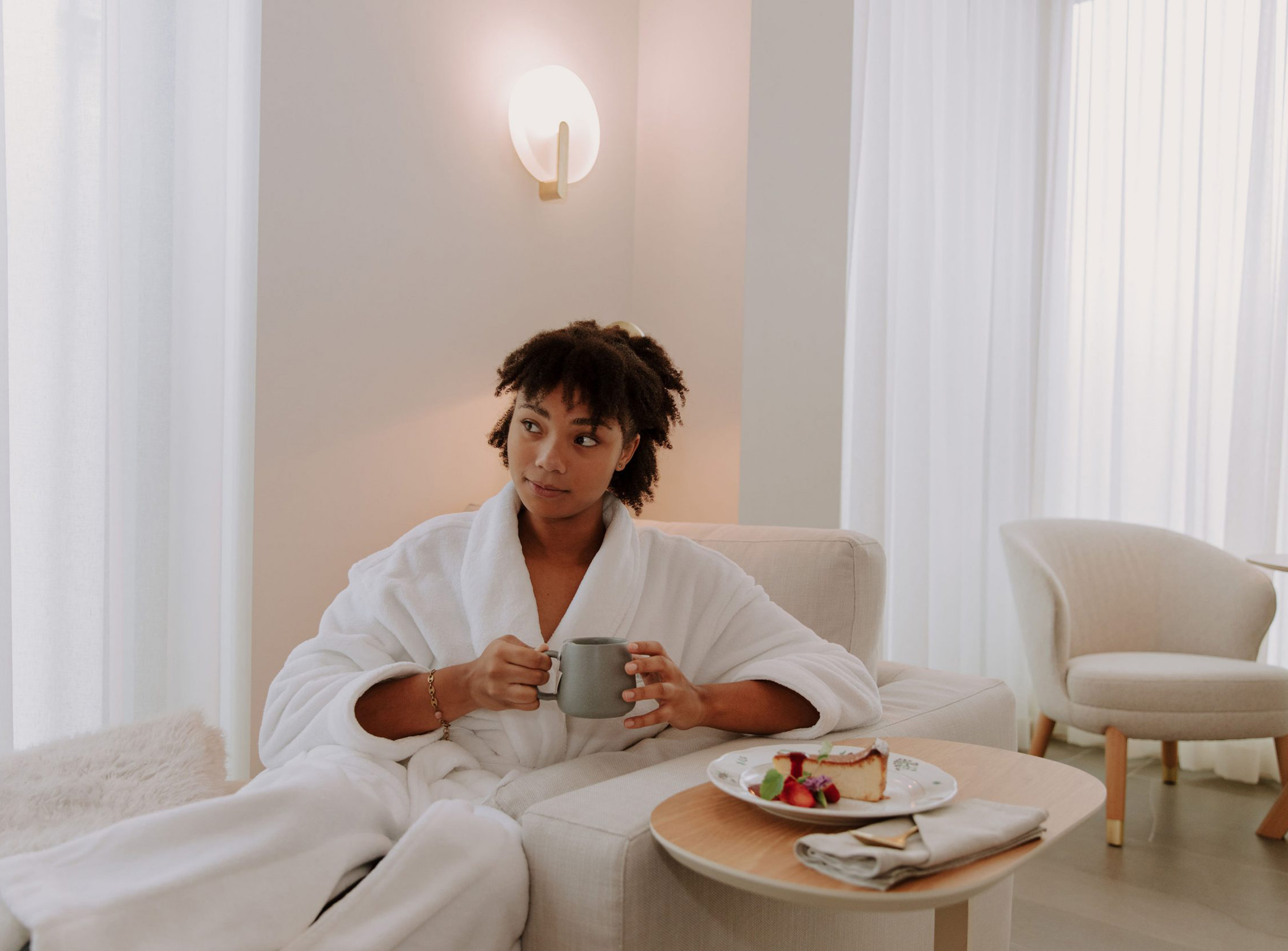 Woman drinking coffee in a spa robe